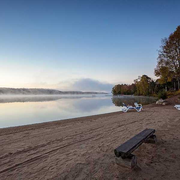 A beach on a misty lake