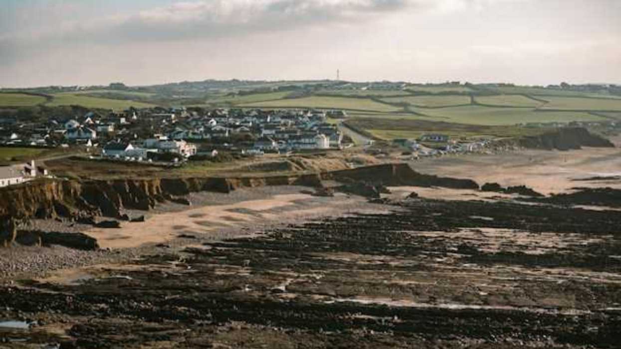 A beach with houses on it and dried up land