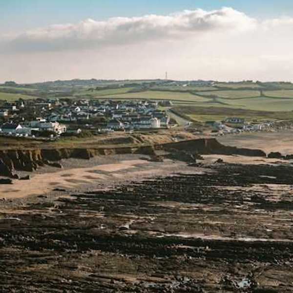 A beach with houses on it and dried up land