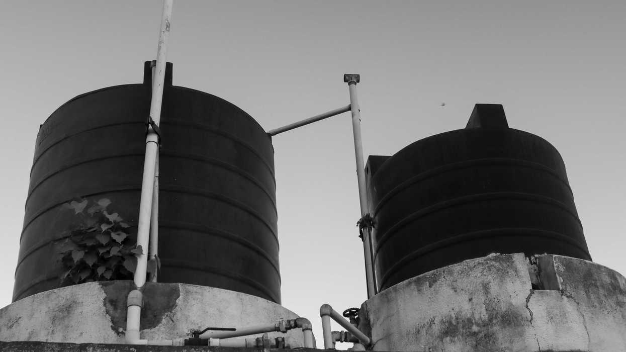 a black and white photo of two large tanks.