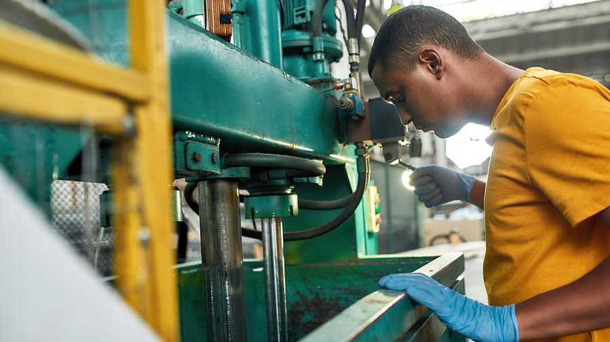 A black man working in a factory