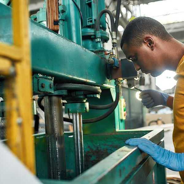 A black man working in a factory