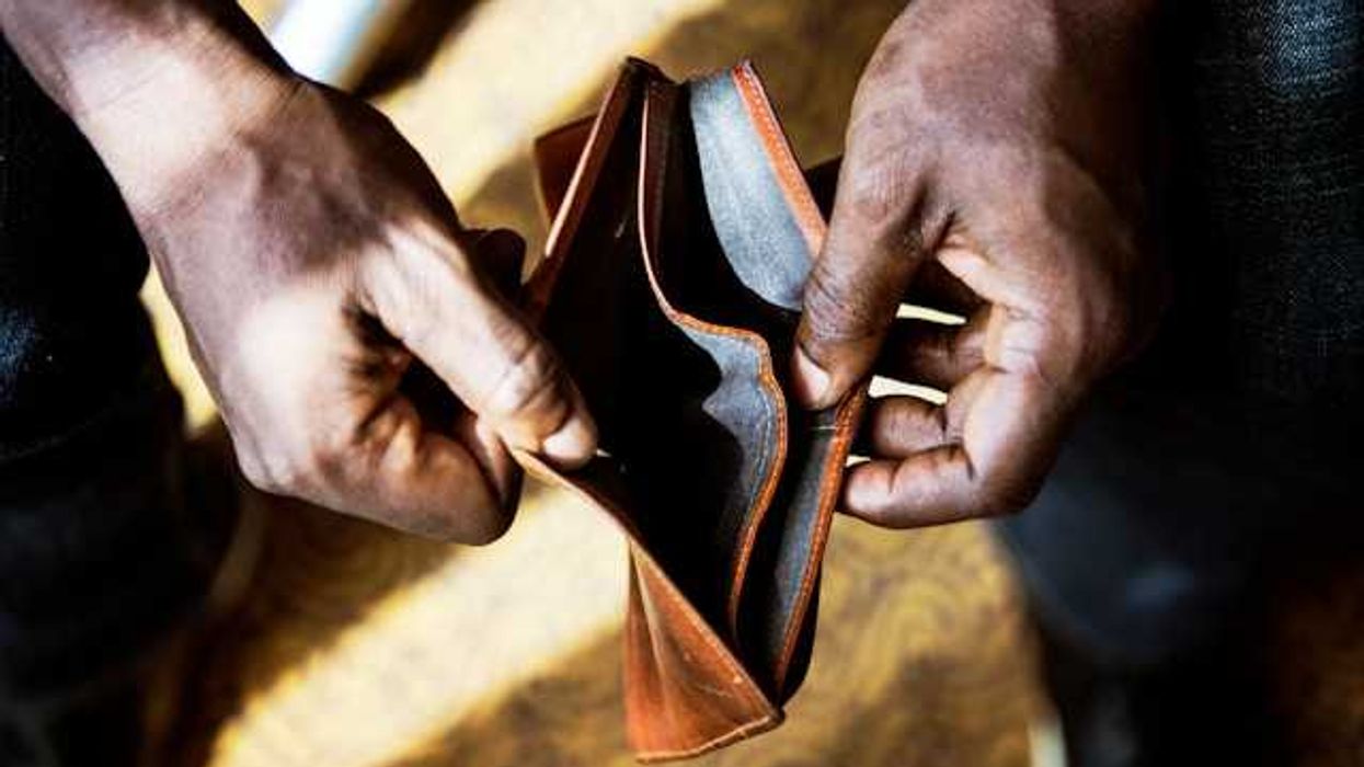 A Black person's hands holding an empty wallet