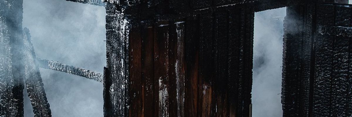 A blackened shell of a burned home.