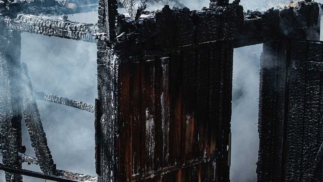 A blackened shell of a burned home.