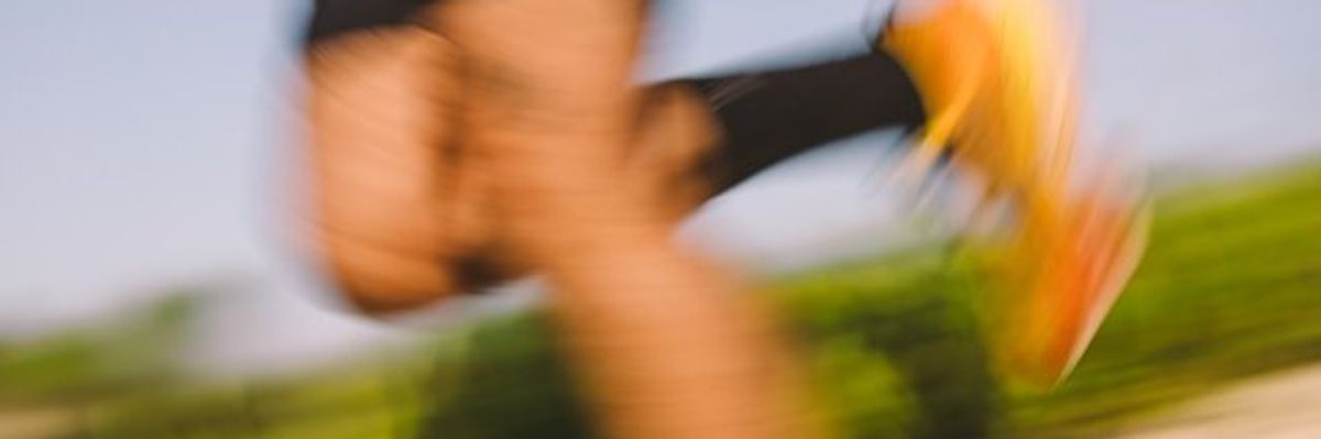 A blurry picture of a jogger's legs.