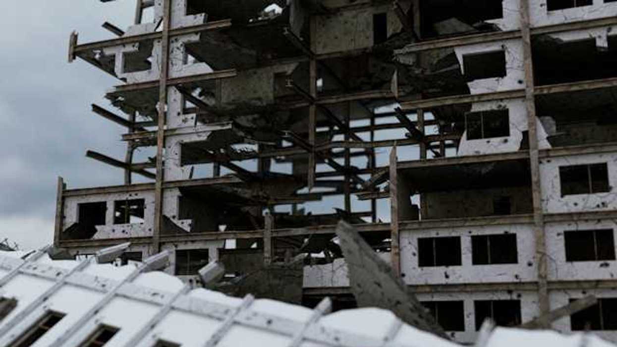 A bombed building against a grey sky