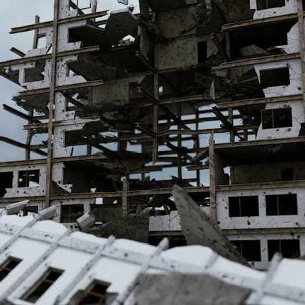 A bombed building against a grey sky
