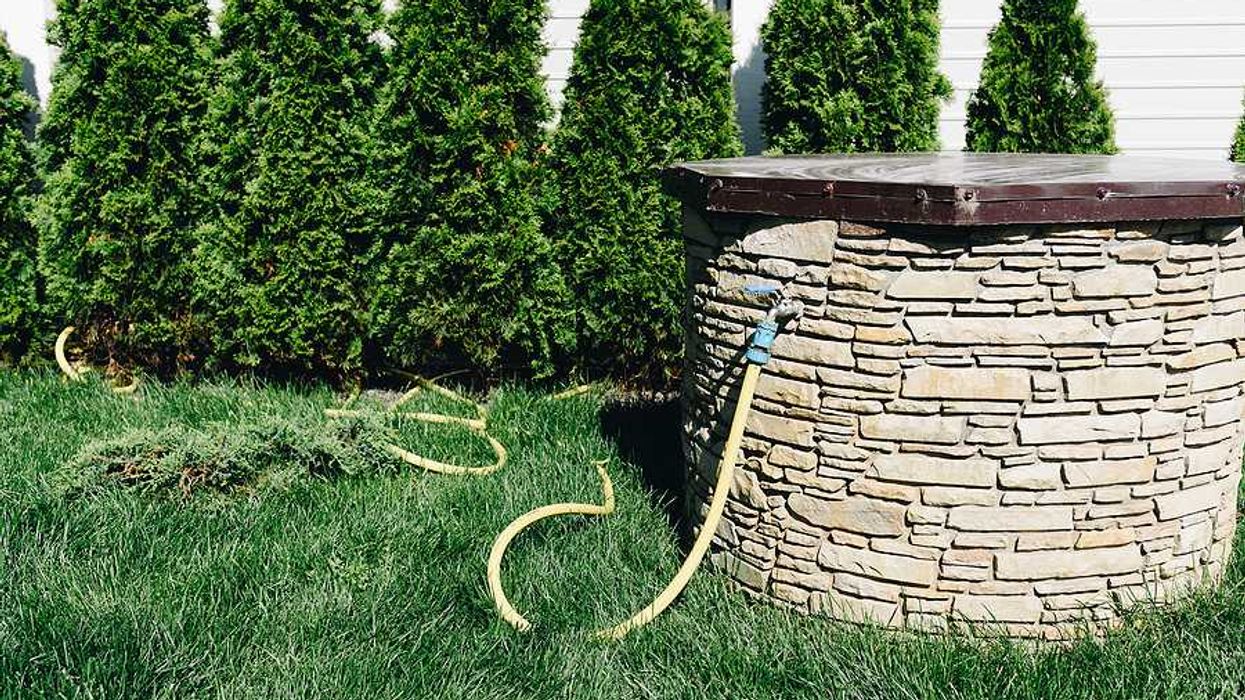A brick enclosed private well set in a lawn