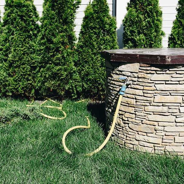 A brick enclosed private well set in a lawn