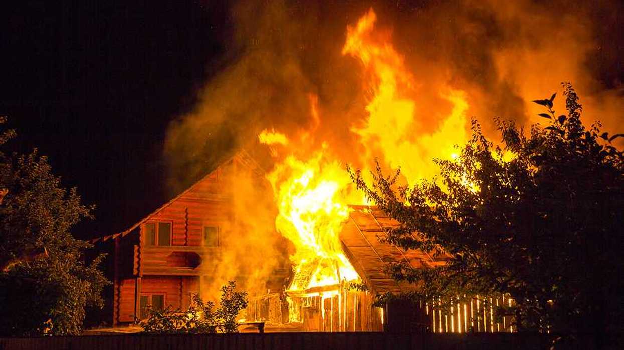 A burning home viewed at night