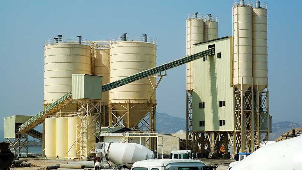A cement plant with trucks in the foreground