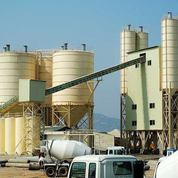 A cement plant with trucks in the foreground