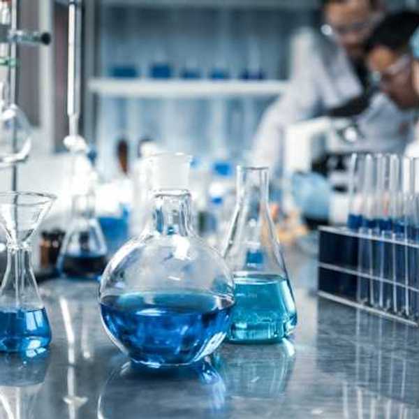 A chemistry lab with beakers filled with blue liquid