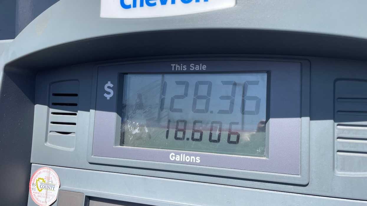 A Chevron gas pump showing a sale of $128.36 for 18.606 gallons