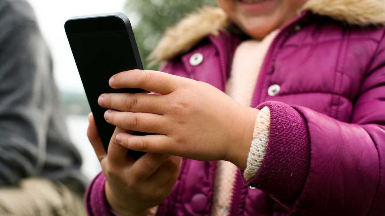 A child holds a cell phone