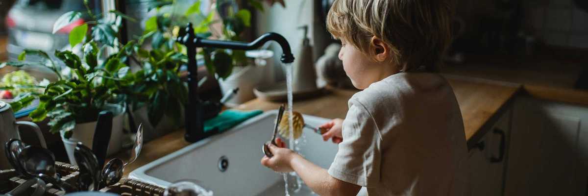 A child plays in sink water