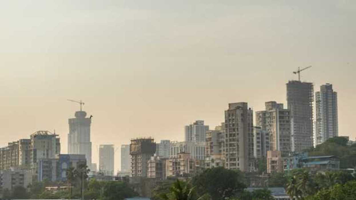 A city skyline with a layer of haze above the buildings