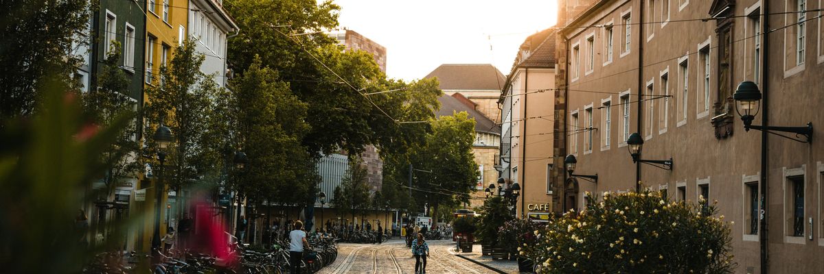 a city street with a train track running through it.
