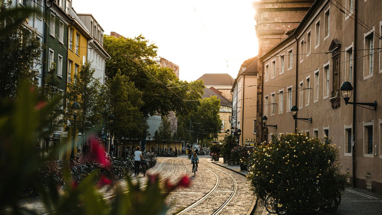 a city street with a train track running through it.