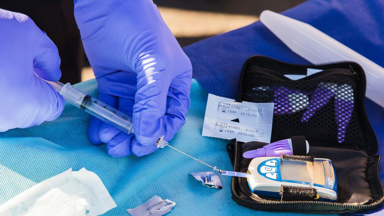 A clinician conducts an insulin level test