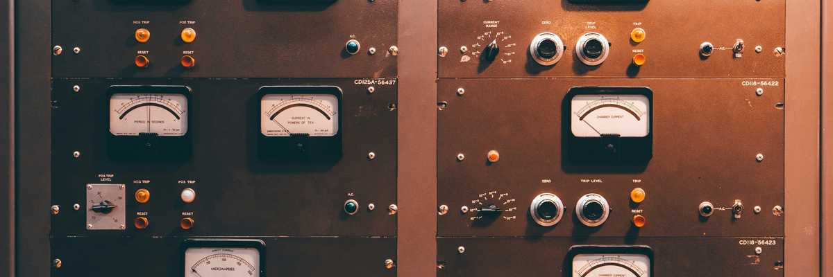 a close up of a control panel with knobs and gauges.