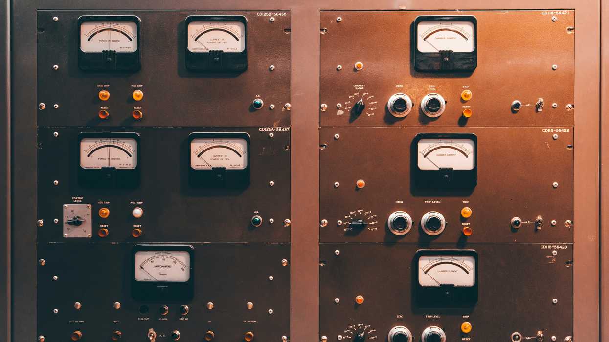 a close up of a control panel with knobs and gauges.