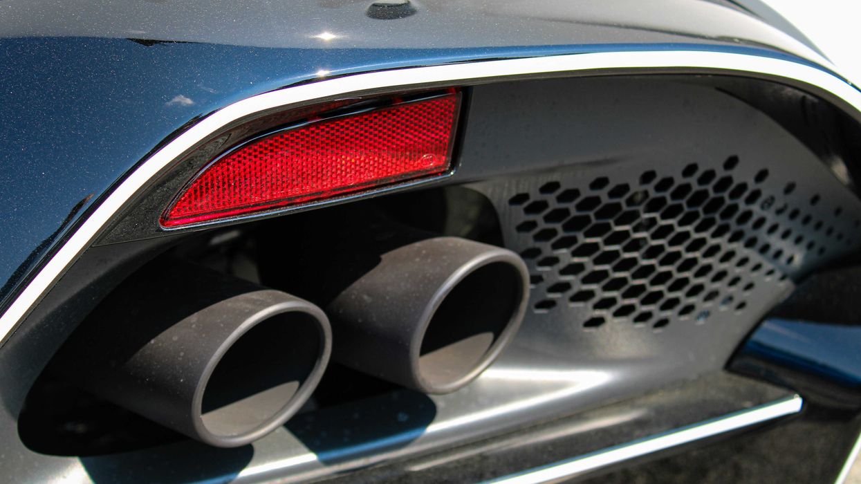 a close up of the tail lights and exhaust pipes of a car.