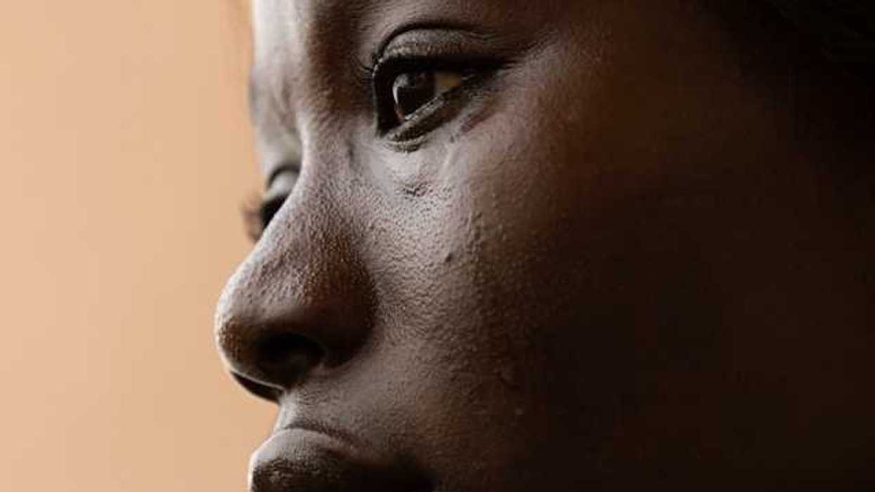A closeup of a crying Black woman