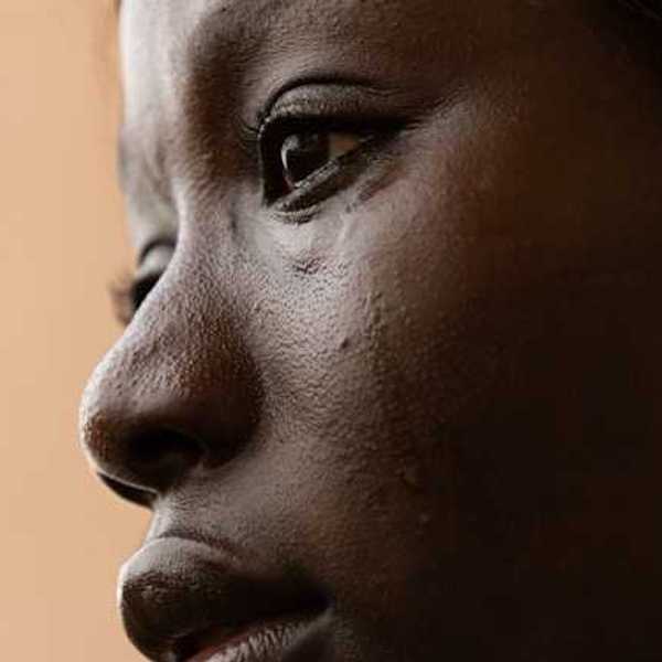 A closeup of a crying Black woman