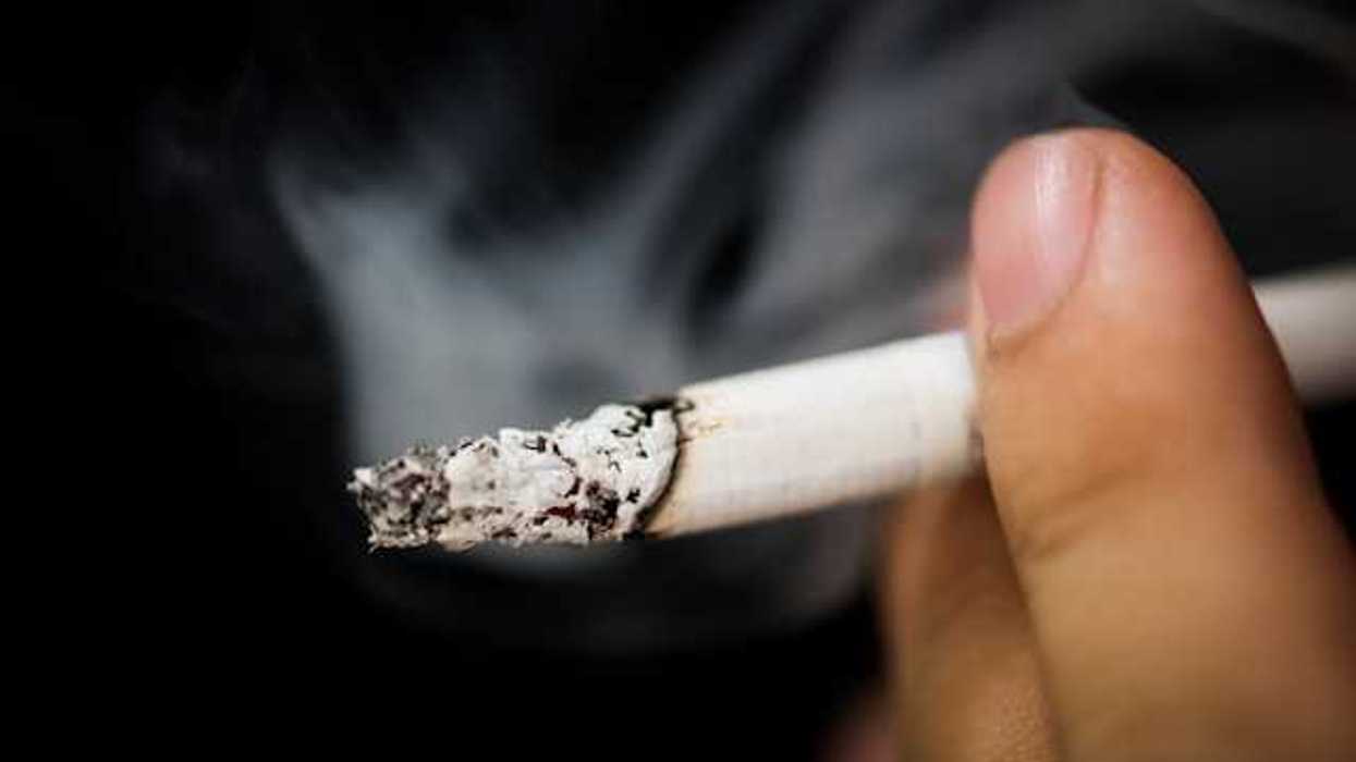 A closeup of a person smoking a cigarette