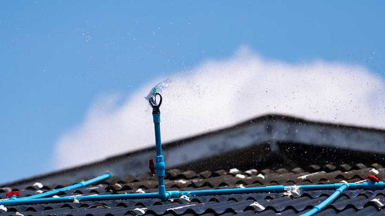 A closeup of a roof with a sprinkler system installed on it