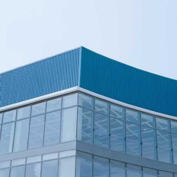 A closeup of the corner of a glass and metal building