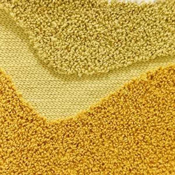 A closeup of yellow carpet
