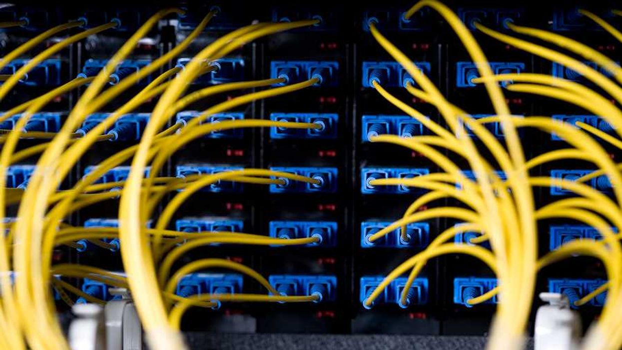 A closeup view of a data server with wires and cords attached