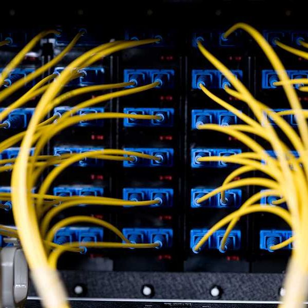 A closeup view of a data server with wires and cords attached