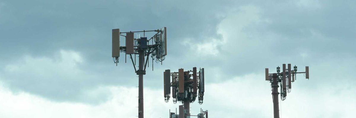 A cluster of cell towers near a mountain