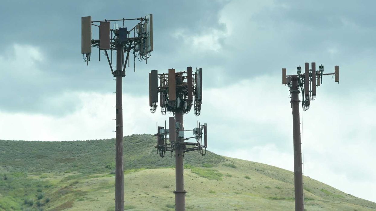 A cluster of cell towers near a mountain
