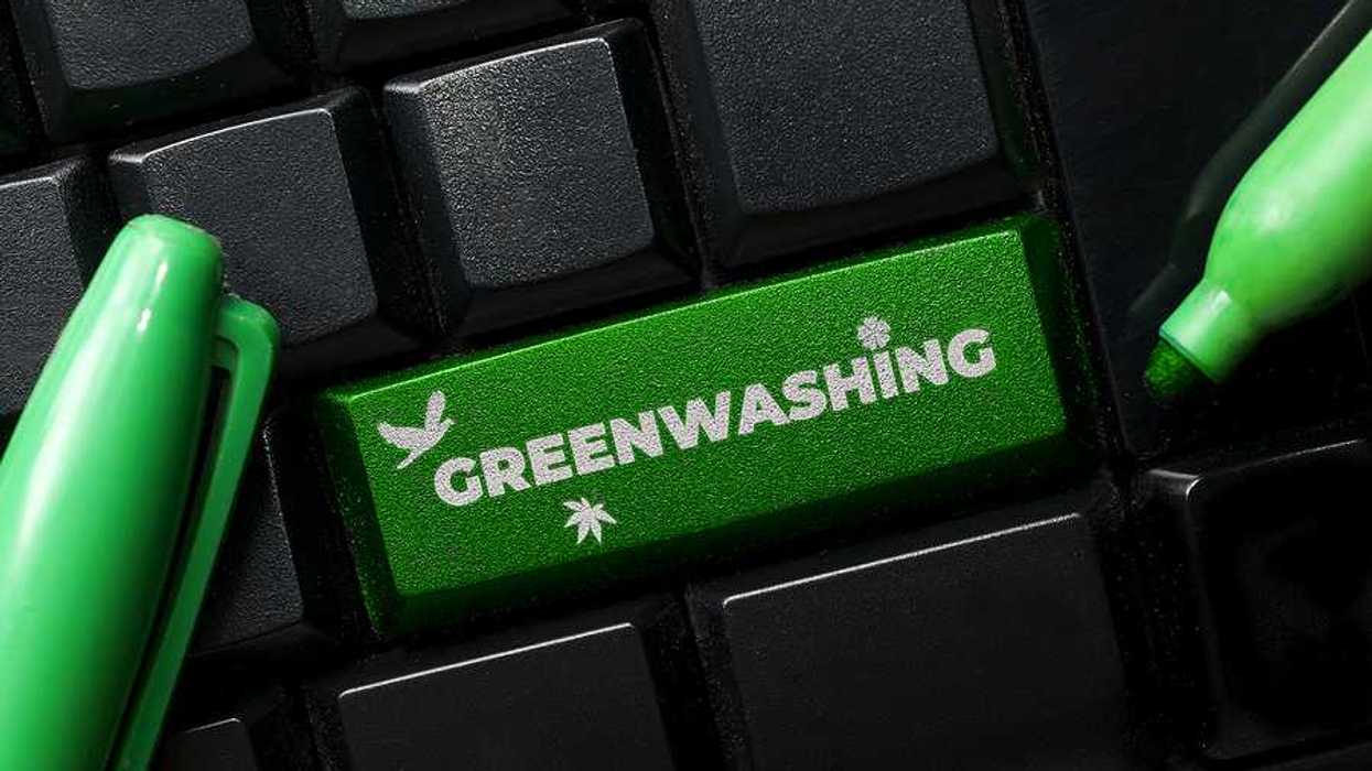 A computer keyboard with a green button called Greenwashing