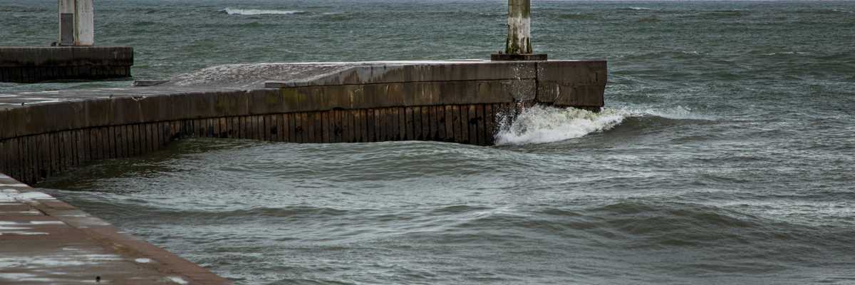 A concrete dock extending into the sea.