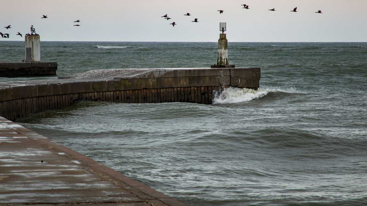 A concrete dock extending into the sea.
