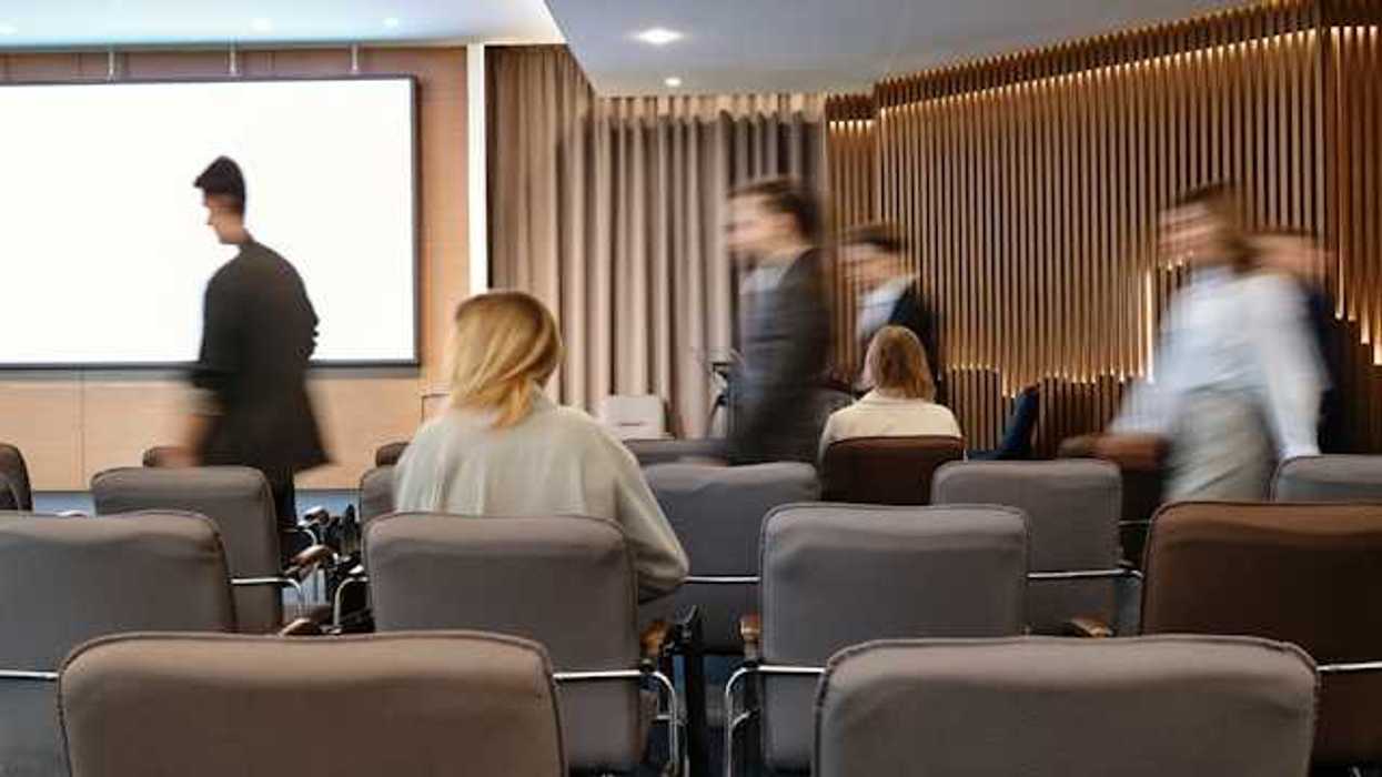 A conference room with people moving about