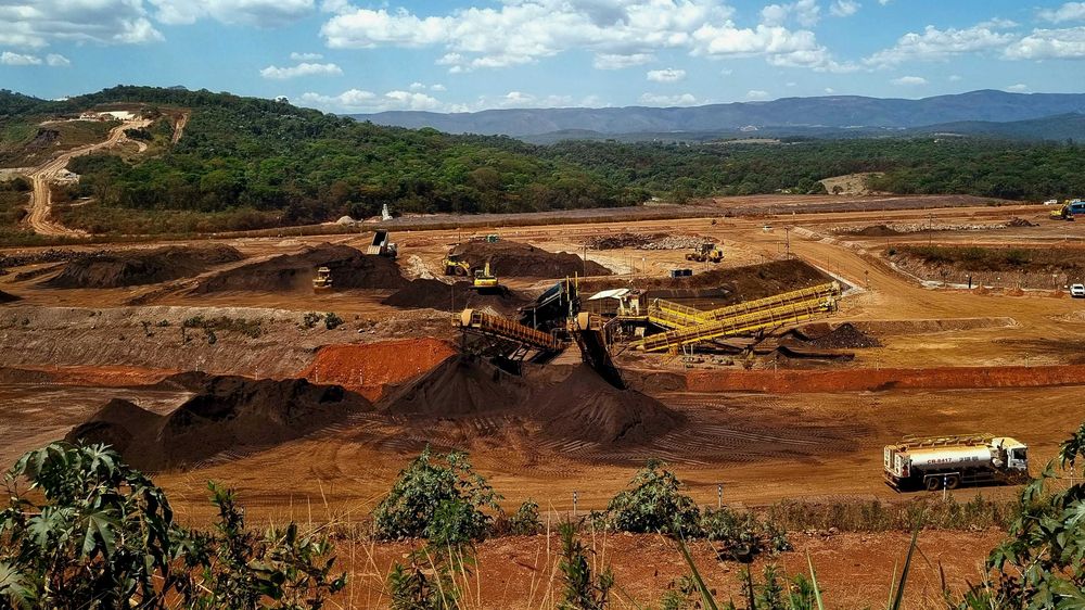 a construction site with a large amount of dirt in the foreground