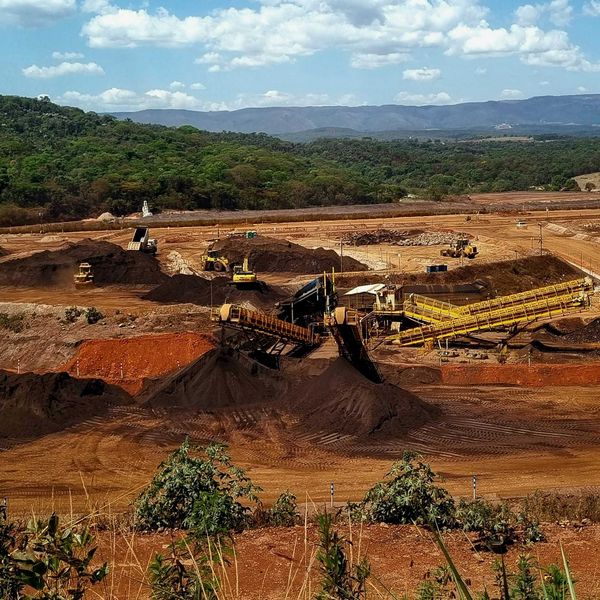 a construction site with a large amount of dirt in the foreground