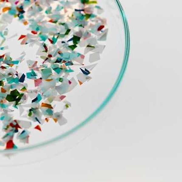 A container with small bits of plastic in it
