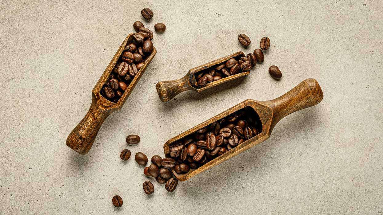 a couple of wooden scoops filled with coffee beans