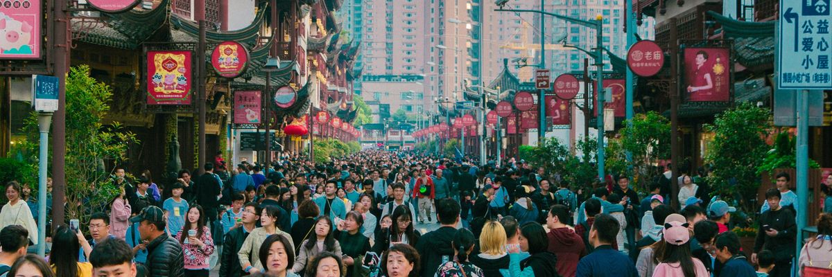 A crowd travels through a city in China