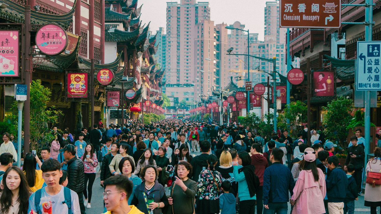 A crowd travels through a city in China