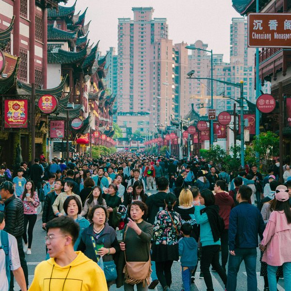 A crowd travels through a city in China