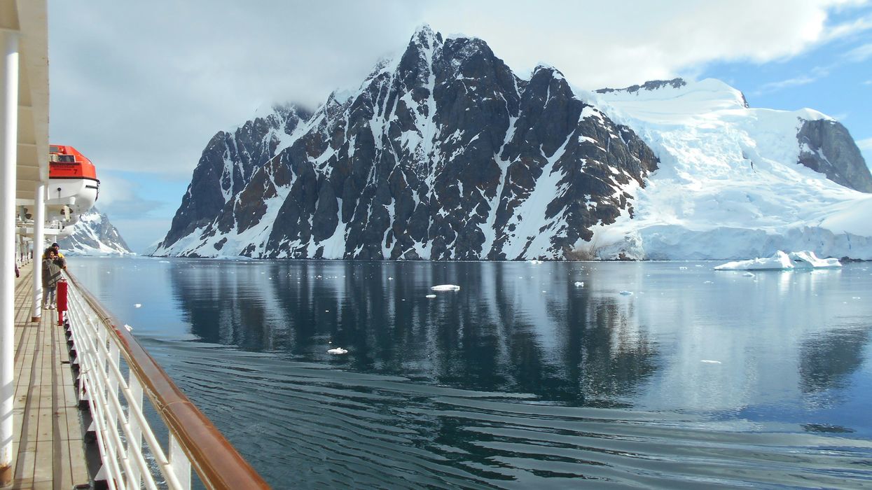 a cruise ship with an iceberg in the background.